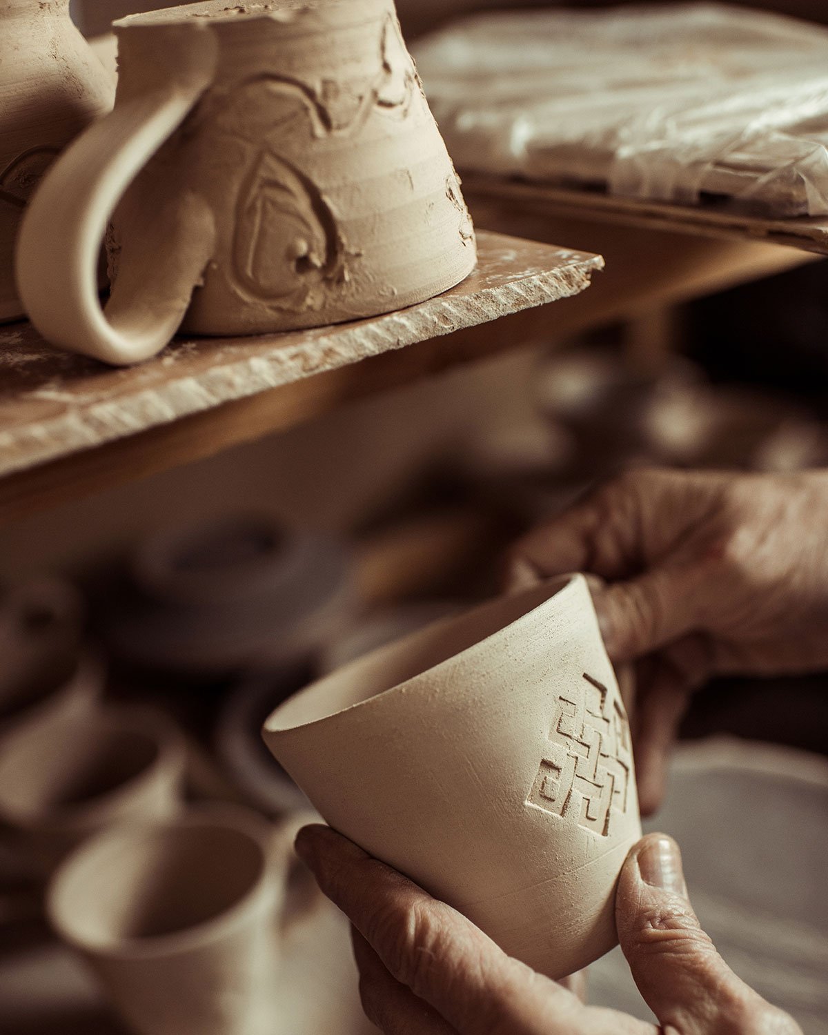 close-up-of-male-hand-of-potter-examining-clay-cup-resize.jpg close-up-of-male-hand-of-potter-examining-clay-cup-resize.jpg